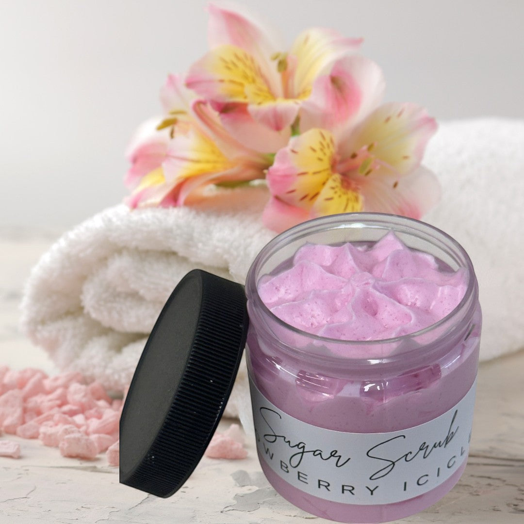 Doodlations Sugar Scrub in Snowberry Icicles scent, a pink exfoliating body scrub in a clear jar with a black lid.