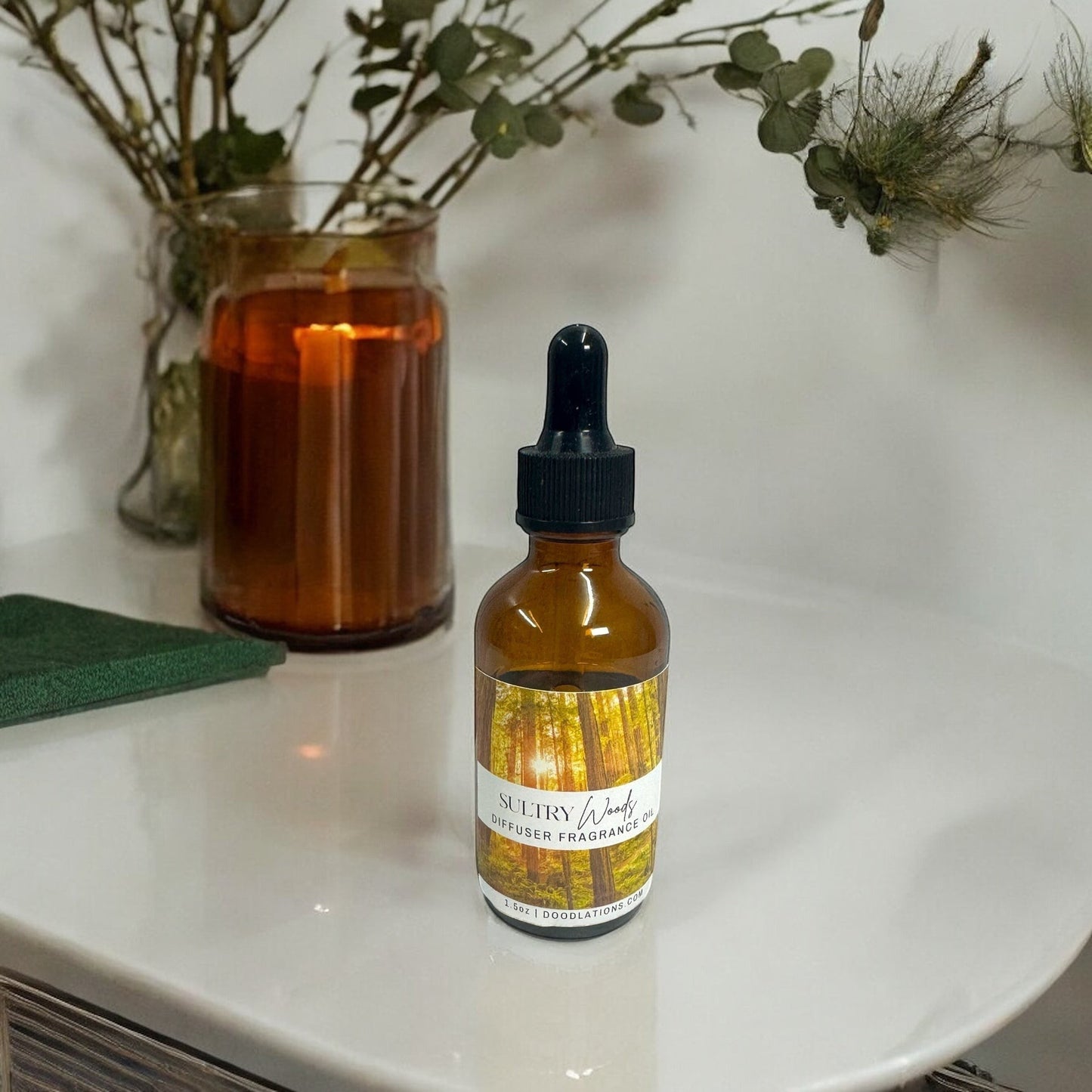 Doodlations Coffee Bar & Boutique Sultry Woods fragrance oil in amber dropper bottle with forest label.