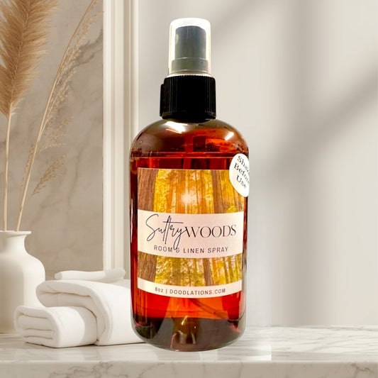 Doodlations Coffee Bar & Boutique Sultry Woods room and linen spray in amber bottle with forest label. 8oz.