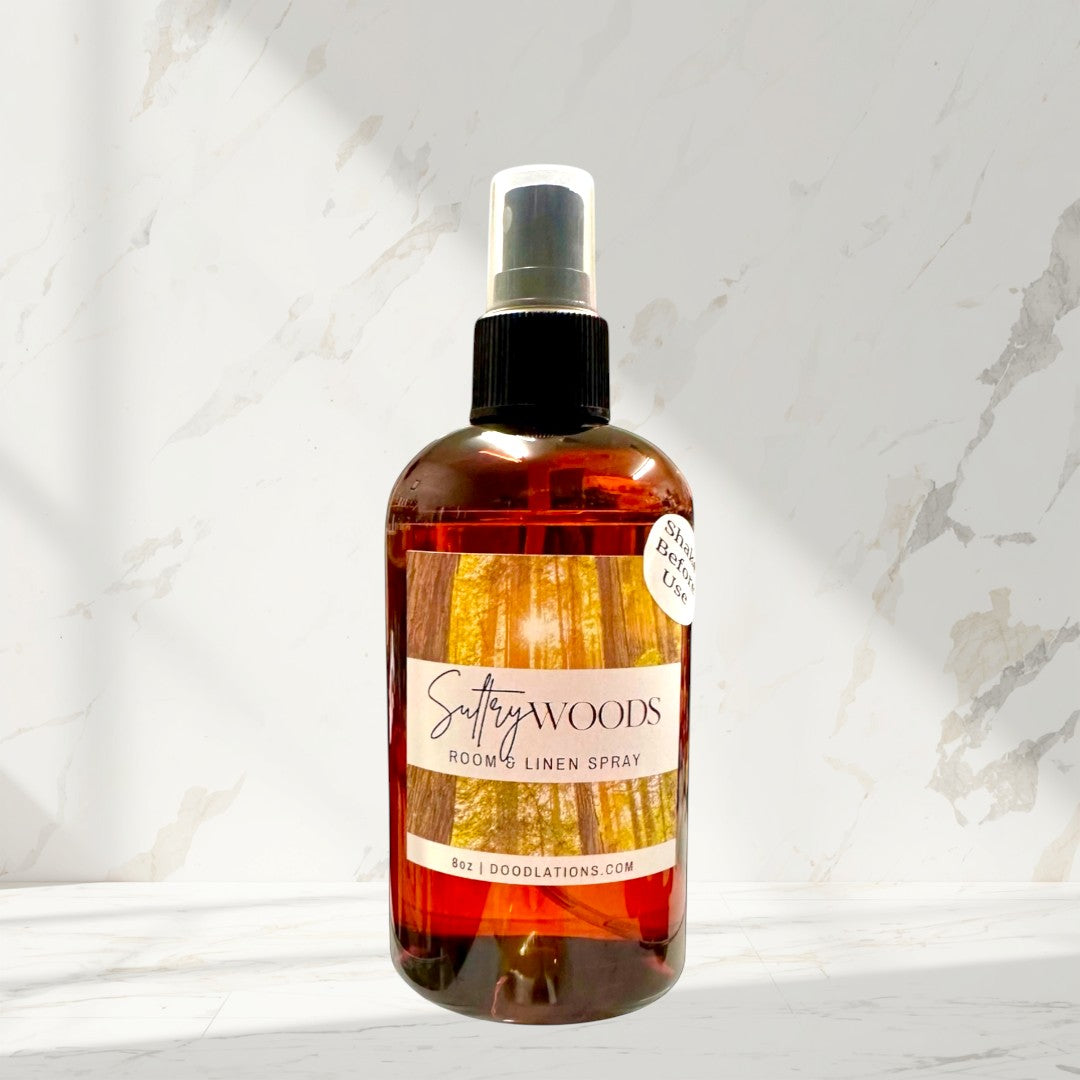 Doodlations Coffee Bar & Boutique Sultry Woods room and linen spray in amber bottle with forest label. 8oz.