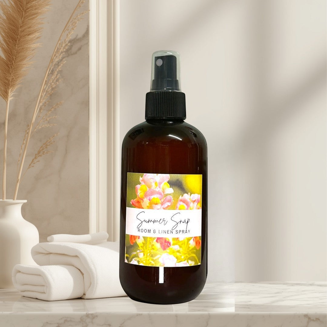 Doodlations Coffee Bar & Boutique Summer Snap Room & Linen Spray with floral and fruit notes in amber bottle.