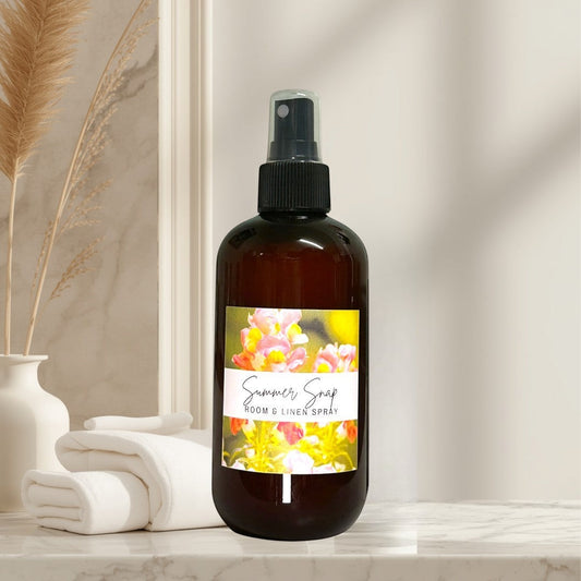 Doodlations Coffee Bar & Boutique Summer Snap Room & Linen Spray with floral and fruit notes in amber bottle.