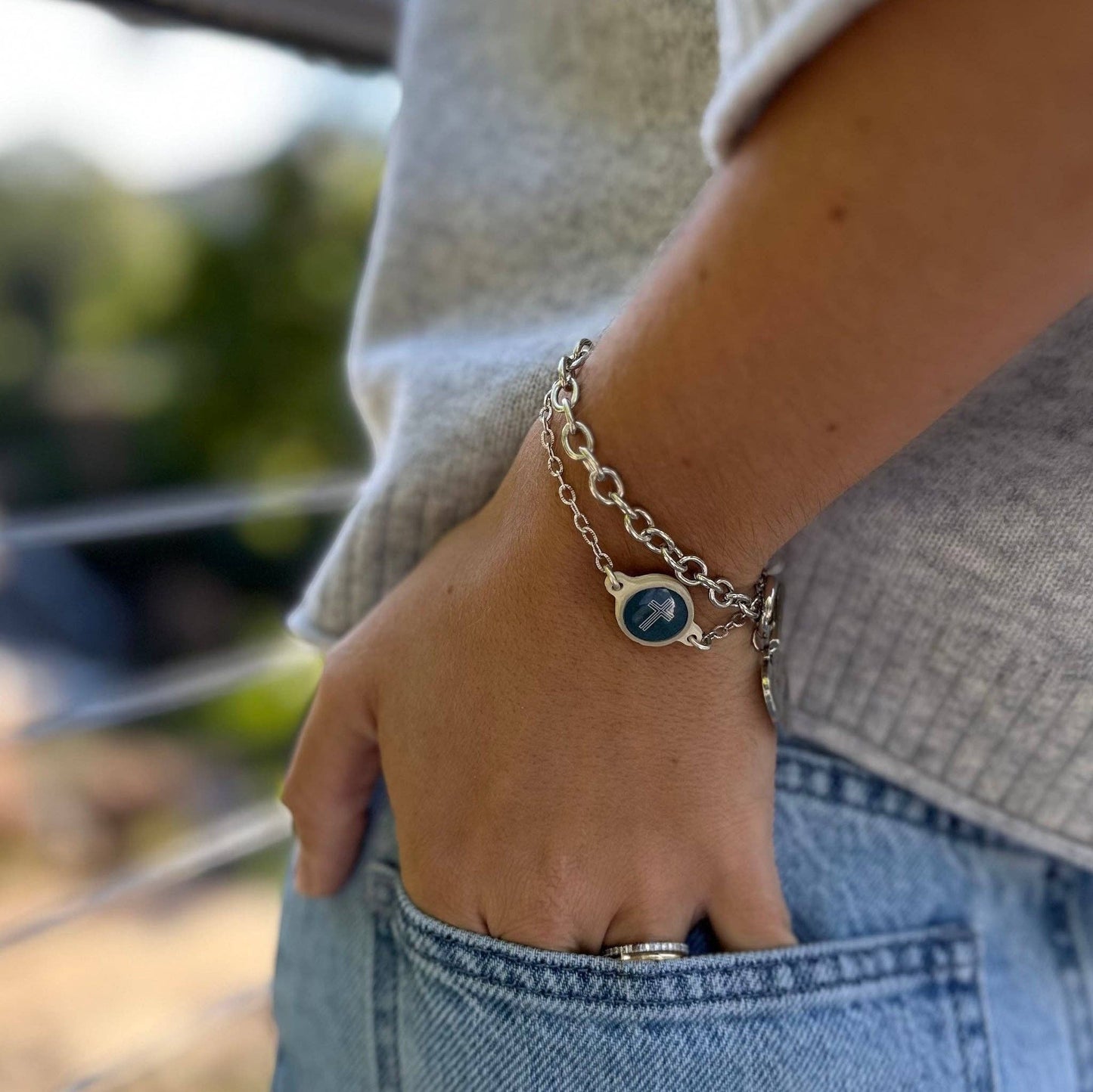 Doodlations Coffee Bar & Boutique Survivor Series Bracelet with moss green cord and silver cross charm, NFC enabled.
