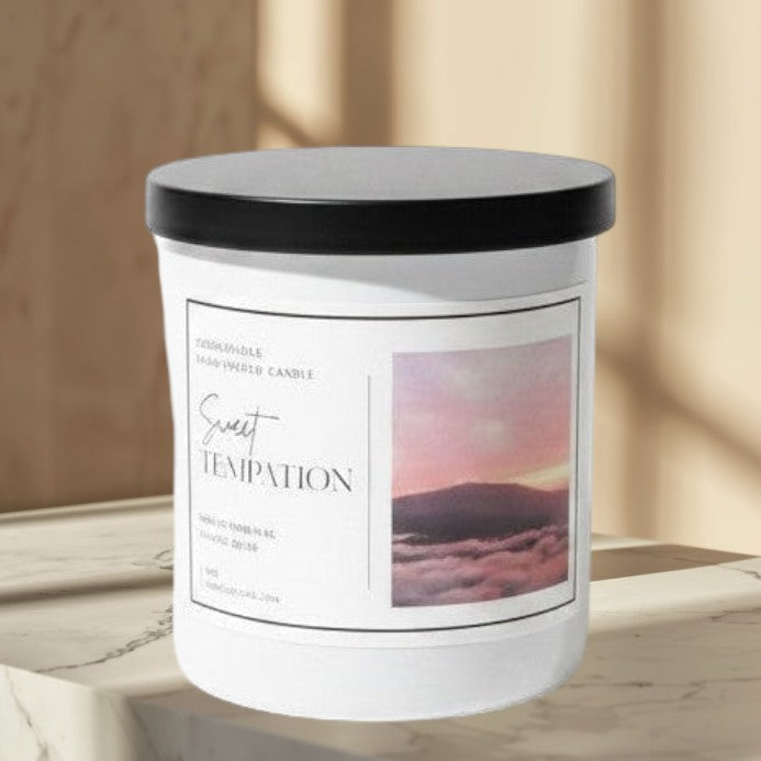 Doodlations Coffee Bar & Boutique Sweet Temptation hand-poured candle with tropical fruit scent, in a white jar with a black lid.