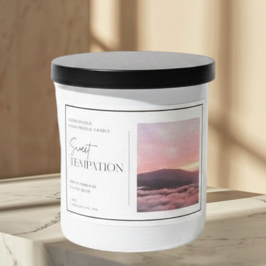 Doodlations Coffee Bar & Boutique Sweet Temptation hand-poured candle with tropical fruit scent, in a white jar with a black lid.