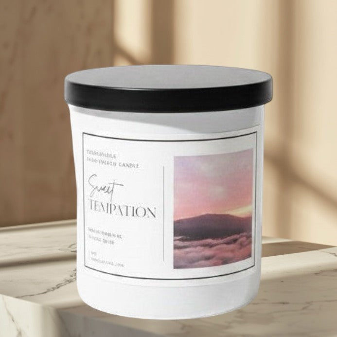 Doodlations Coffee Bar & Boutique Sweet Temptation hand-poured candle with tropical fruit scent, in a white jar with a black lid.