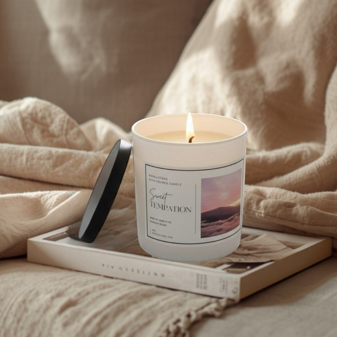 Doodlations Sweet Temptation hand-poured soy candle in a white tin with a black lid, featuring tropical fruit scents.