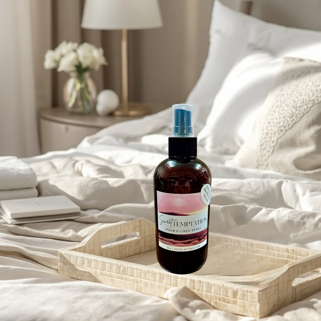 Doodlations Sweet Temptation room and linen spray in a dark amber bottle with a pink and white label.