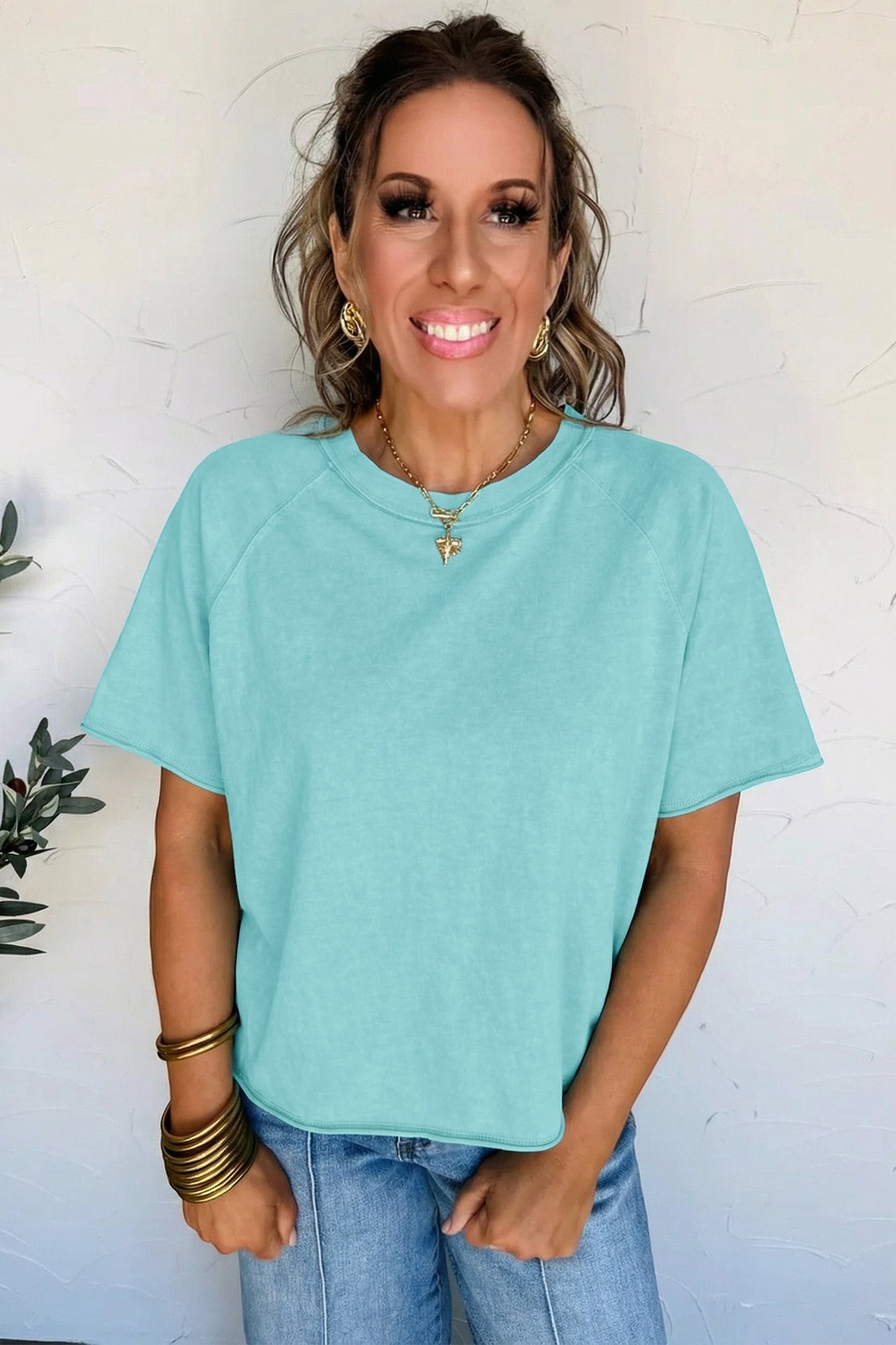 Doodlations Coffee Bar & Boutique teal mineral wash cotton blend tee with raw hem and sleeves.
