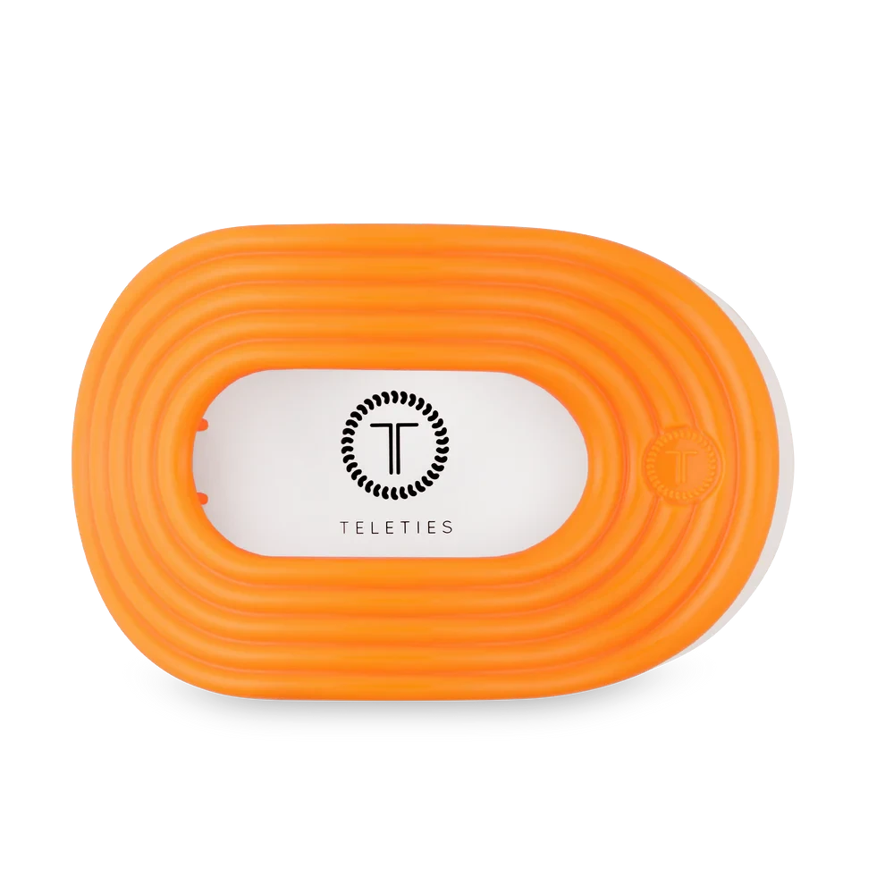 Doodlations Coffee Bar & Boutique Teleties Day Rave flat round orange hair clip for sectioning and styling.
