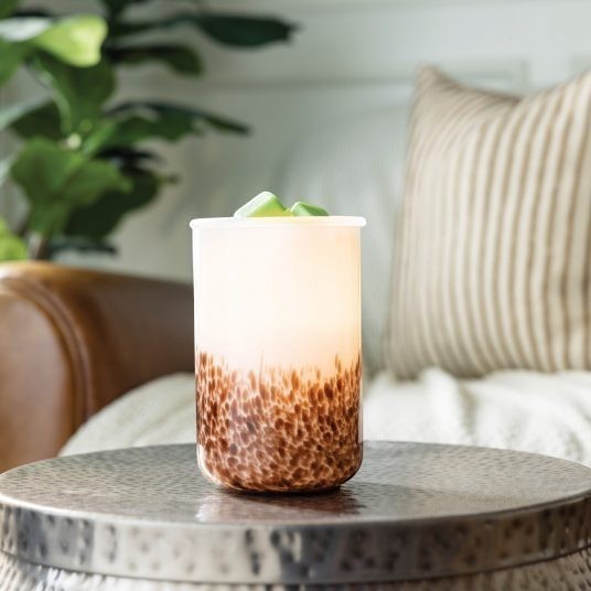 Doodlations Tiger Shell Illumination Wax Warmer with a speckled brown base and frosted top, emitting a warm glow.