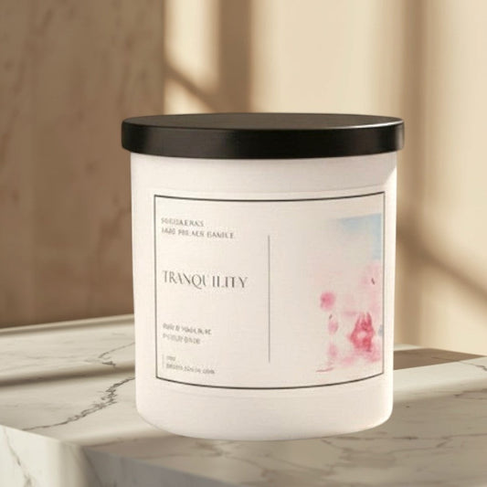 Doodlations Coffee Bar & Boutique Tranquility candle with lemongrass, clove, lavender, and musk scents. Steam rising.