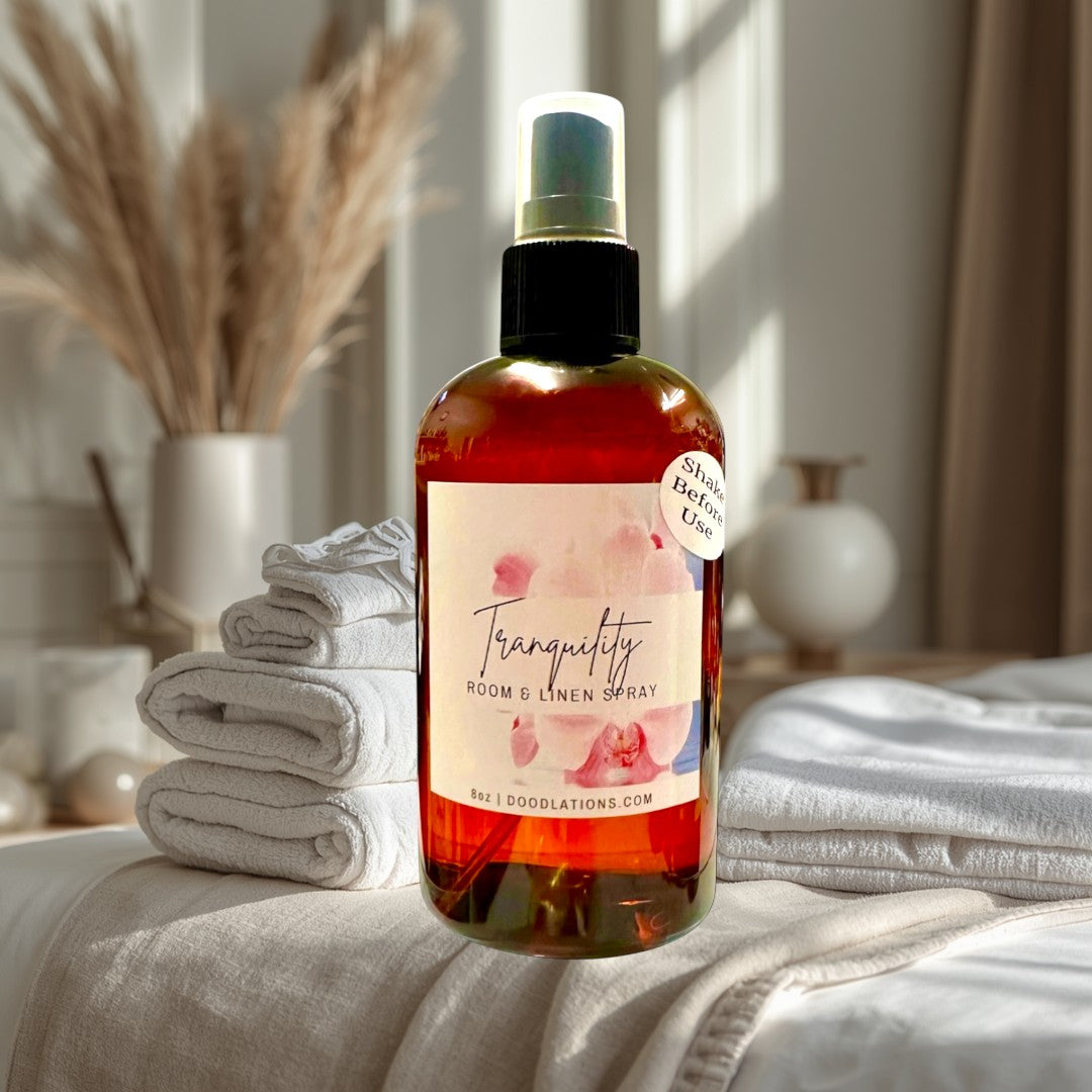 Doodlations Tranquility Room & Linen Spray with lemongrass, clove, lavender, and musk scents. Amber bottle, 8oz.