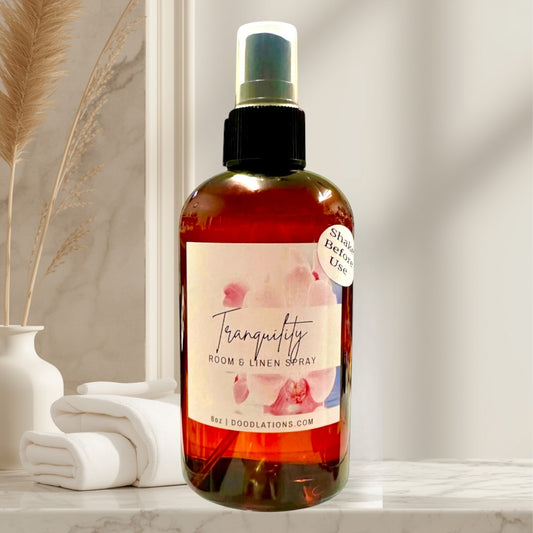 Doodlations Tranquility Room & Linen Spray with lemongrass, clove, lavender, and musk scents. 8oz amber bottle.