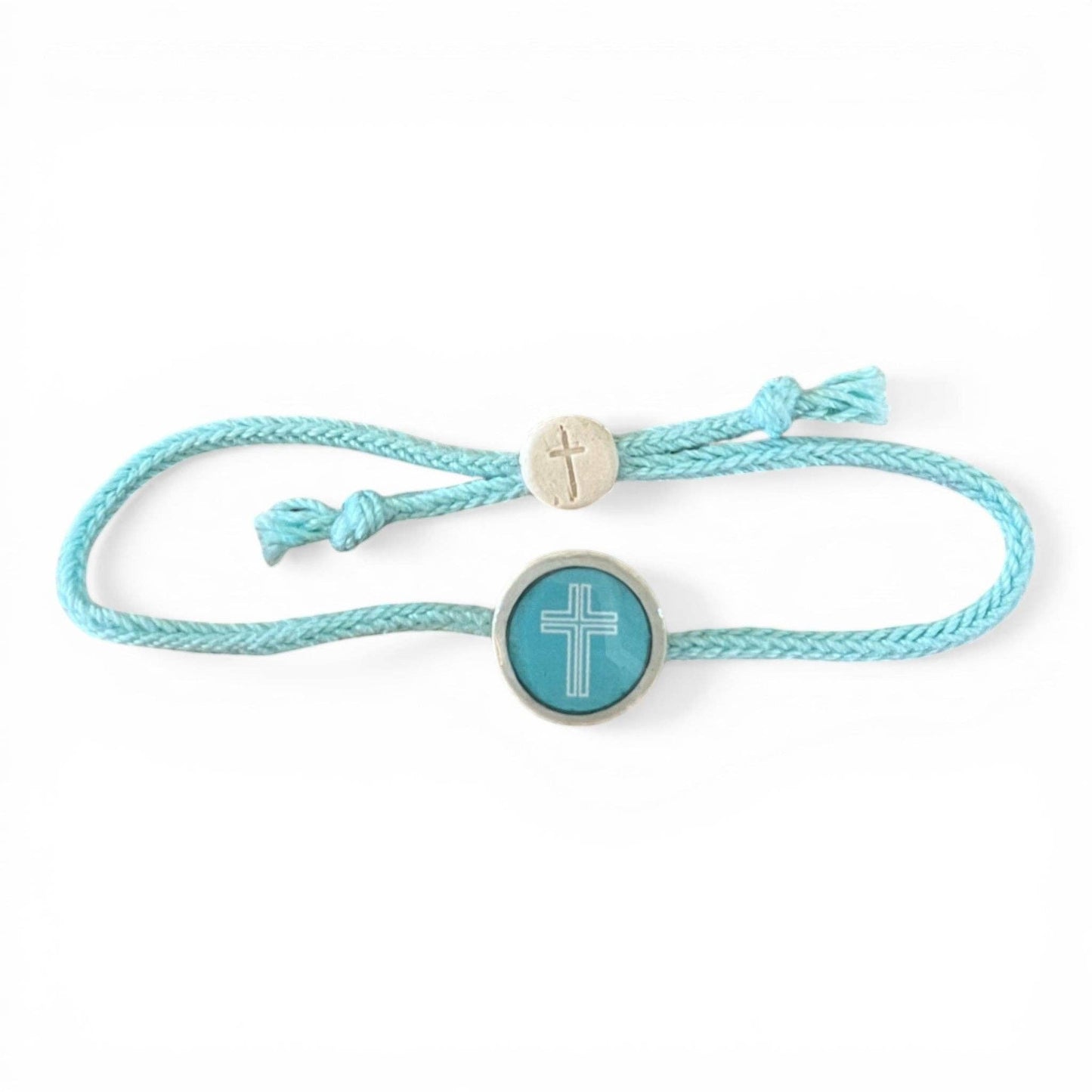 Doodlations Coffee Bar & Boutique turquoise cord bracelet with a central cross charm and a smaller bead with a cross.
