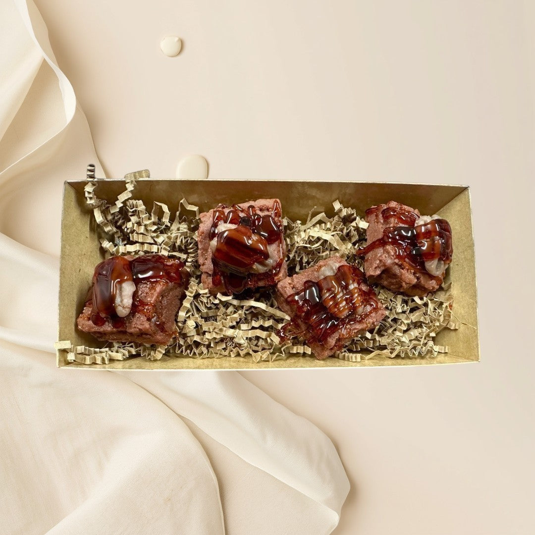 Doodlations Coffee Bar & Boutique Turtle Brownie Bite Wax Melts with chocolate drizzle and pecans.