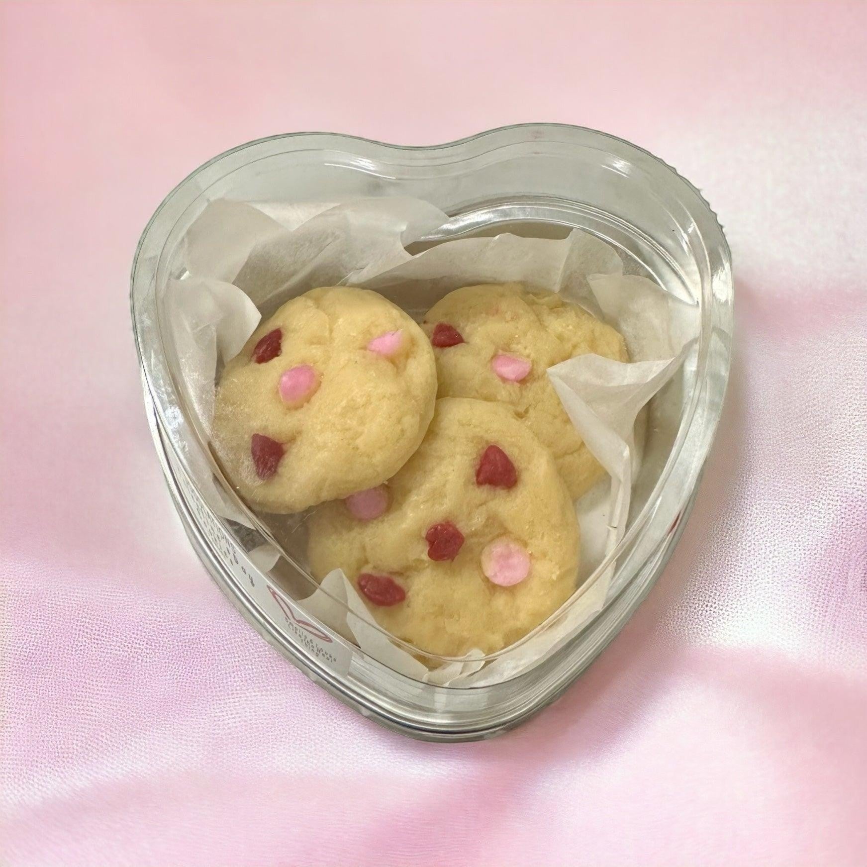 Doodlations Coffee Bar & Boutique Valentines Day sugar cookie wax melts with pink and red candy pieces in a heart-shaped container.