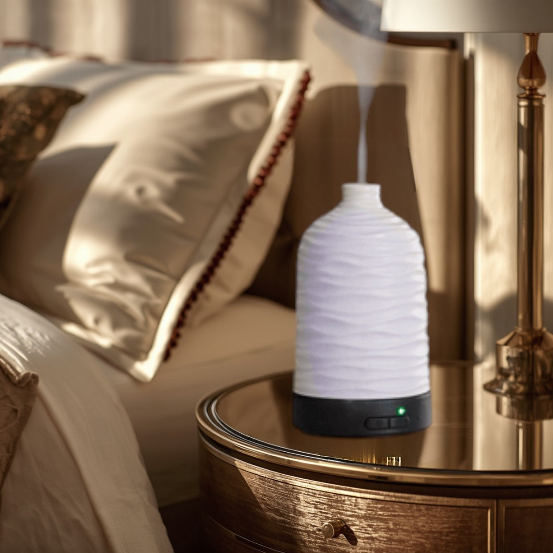 Doodlations white ceramic water droplet aroma diffuser with wavy texture, emitting a gentle mist. Perfect for aromatherapy.