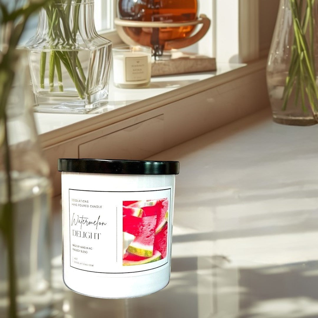 Doodlations Watermelon Delight hand-poured soy blend candle with a black lid, featuring a label with sliced watermelon.