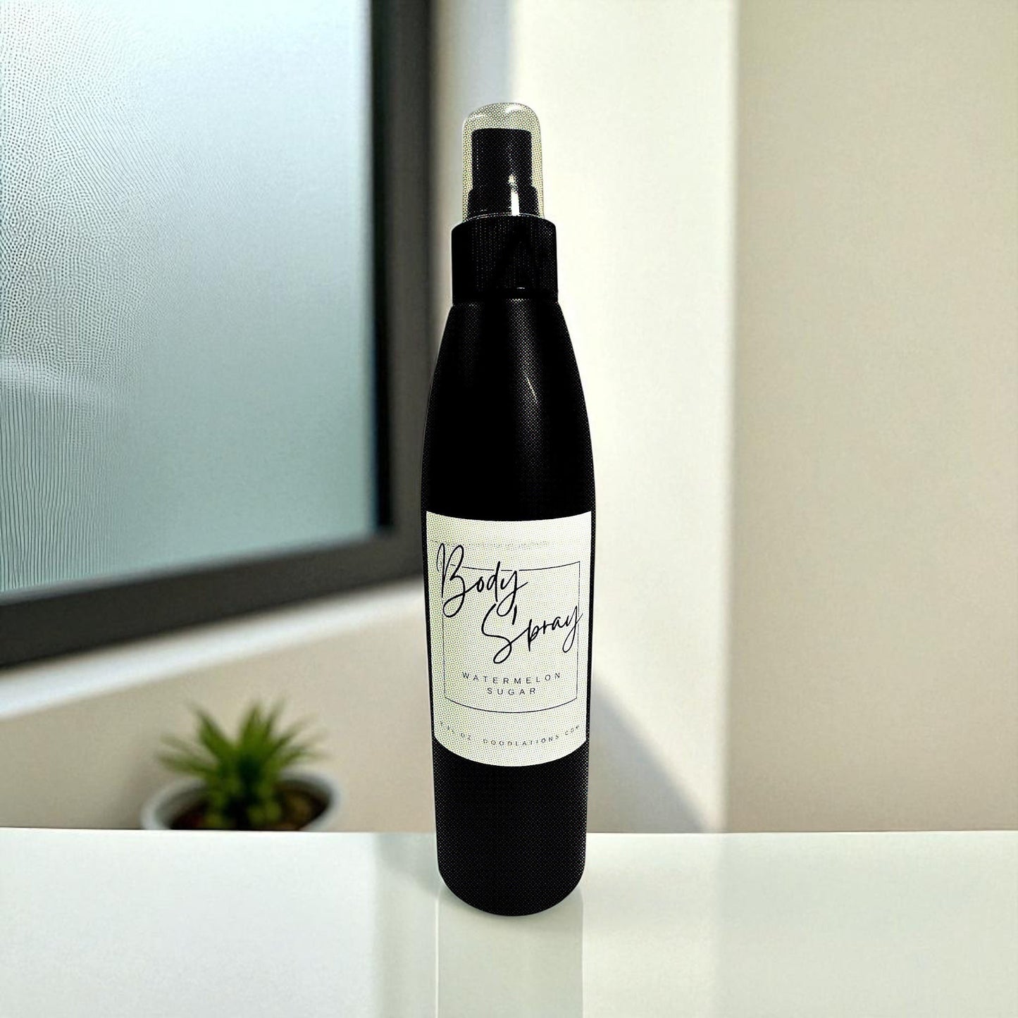 Doodlations Coffee Bar & Boutique Watermelon Sugar Moisturizing Body Spray in a black bottle with a white label.