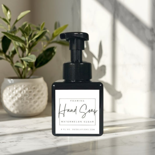 Doodlations Watermelon Sugar foaming hand soap in a black square bottle with a black pump dispenser. White label with black text.