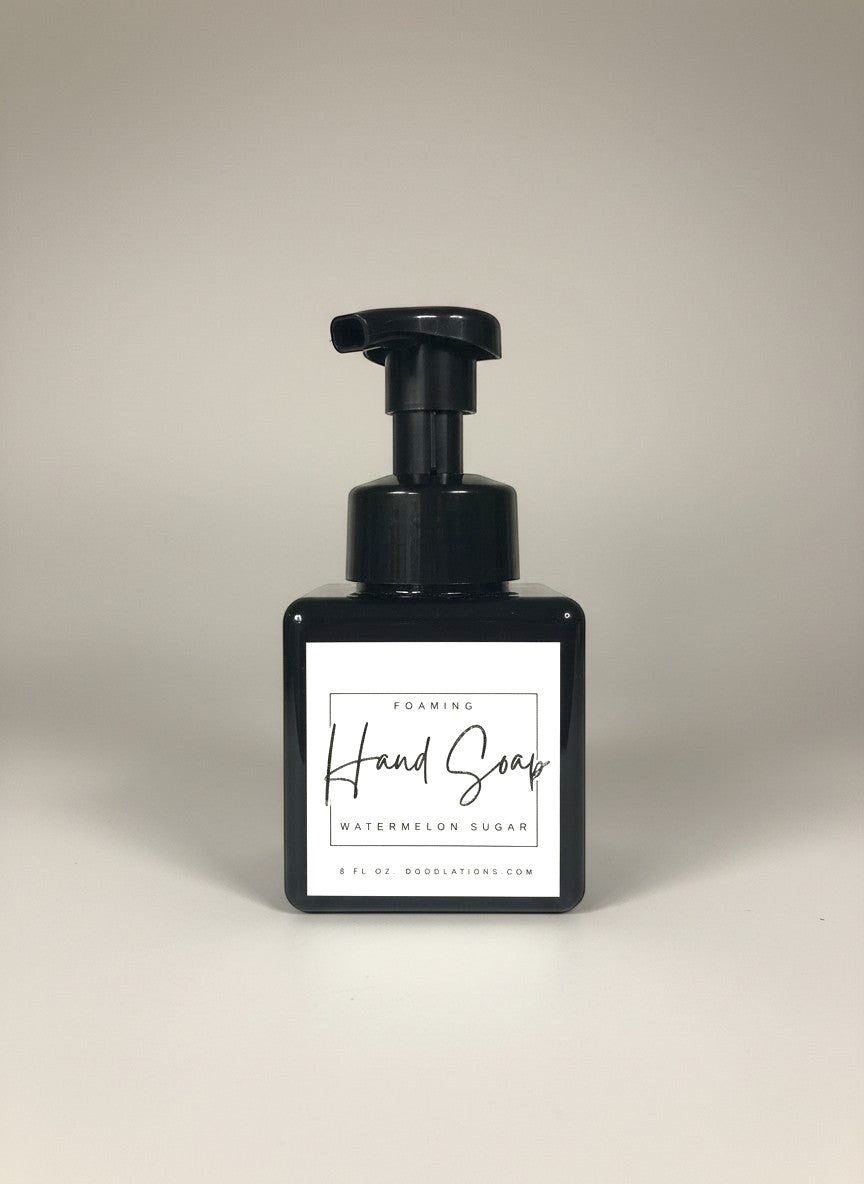 Doodlations Watermelon Sugar foaming hand soap in a black square bottle with a black pump dispenser. White label with black text.