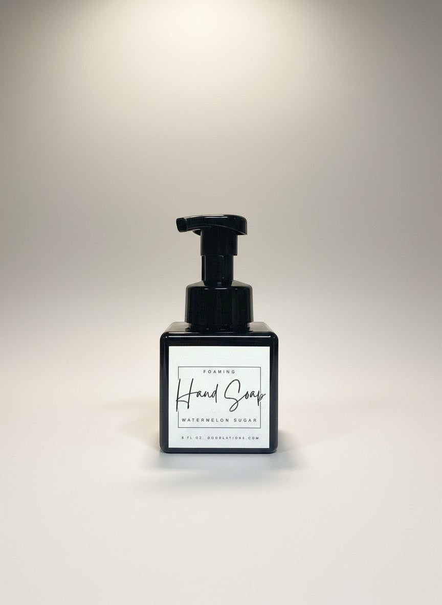 Doodlations Watermelon Sugar foaming hand soap in a square black bottle with a black pump dispenser. White label with black text.