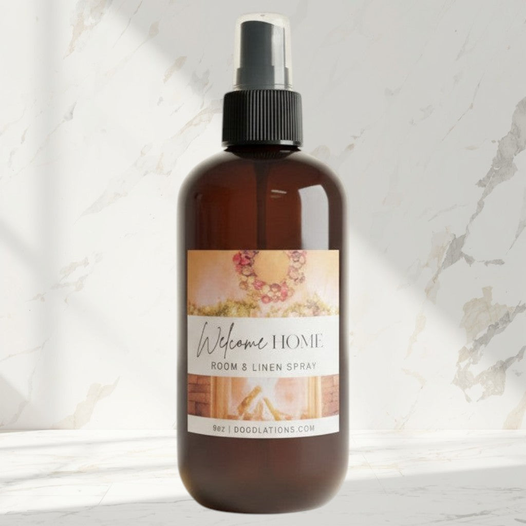 Doodlations Welcome Home room and linen spray in amber glass bottle with black spray top. Cozy scent.