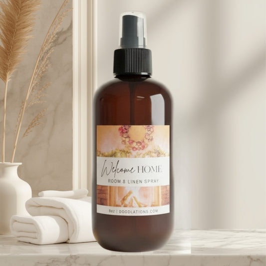 Doodlations Coffee Bar & Boutique Welcome Home Room & Linen Spray with cinnamon, clove, orange, and vanilla scent.
