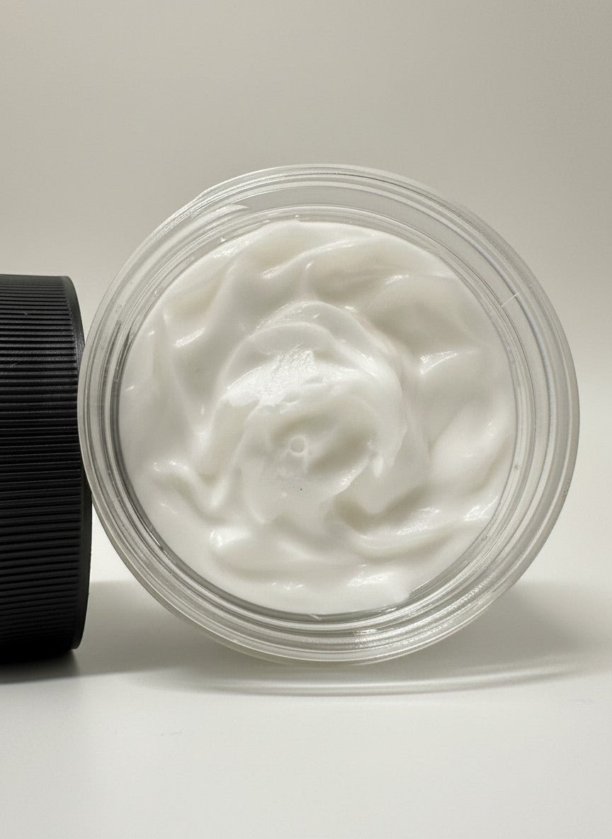 Doodlations Angel Wings Whipped Soap, a luxurious white foaming body wash with a creamy texture in a clear jar.