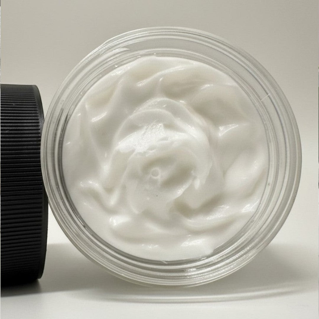 Doodlations Angel Wings Whipped Soap, a luxurious white foaming body wash with a creamy texture in a clear jar.