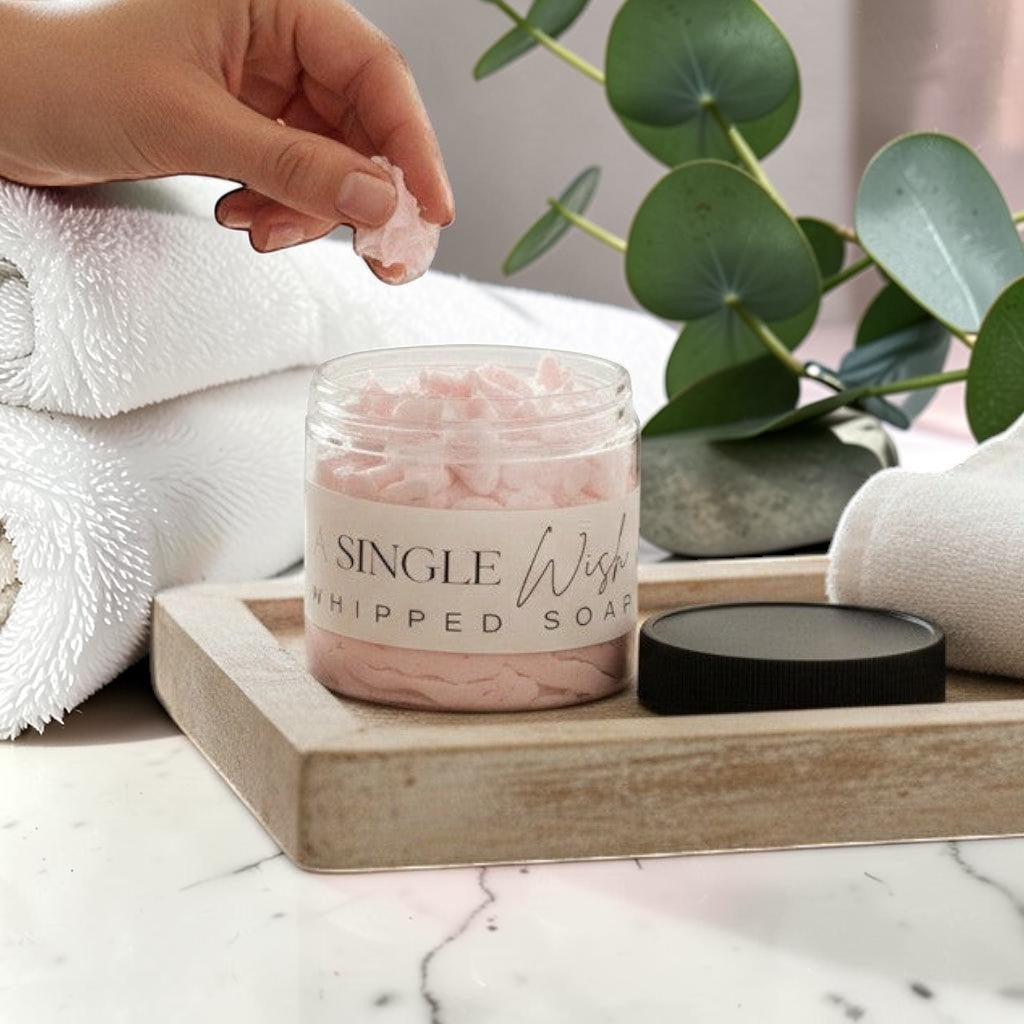 Doodlations Coffee Bar & Boutique Single Wish whipped soap in a clear jar with a black lid. Light pink, fluffy soap with grape seed oil.