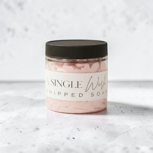 Doodlations Coffee Bar & Boutique Single Wish whipped soap in a clear jar with a black lid. Light pink, fluffy soap with grape seed oil.