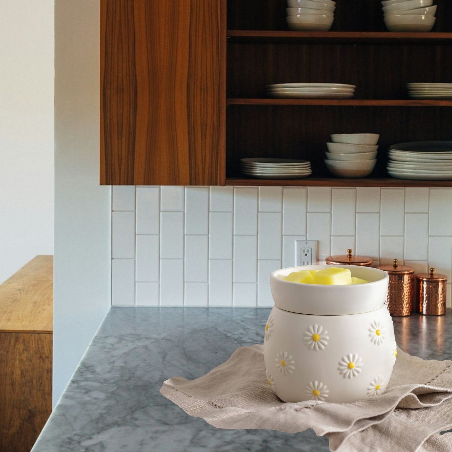 Doodlations white ceramic wax warmer with raised daisy design and yellow centers, holding yellow wax melts.