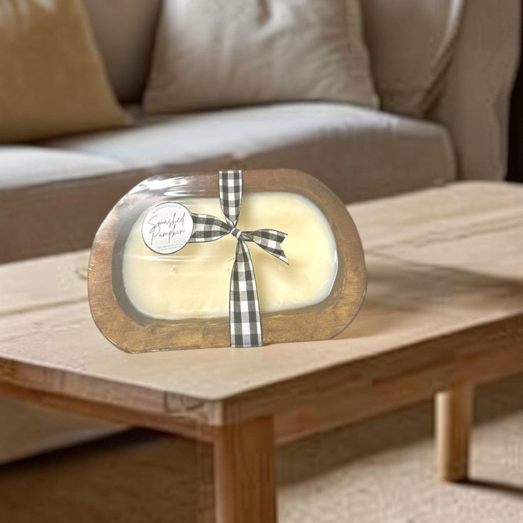 Doodlations Smashed Pumpkin wooden dough bowl candle with black and white buffalo check ribbon.