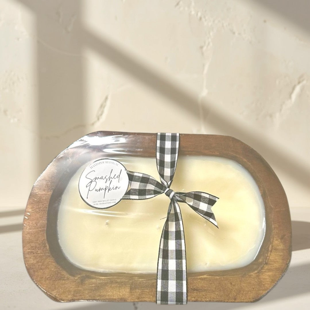 Doodlations Smashed Pumpkin wooden dough bowl candle with black and white buffalo check ribbon.