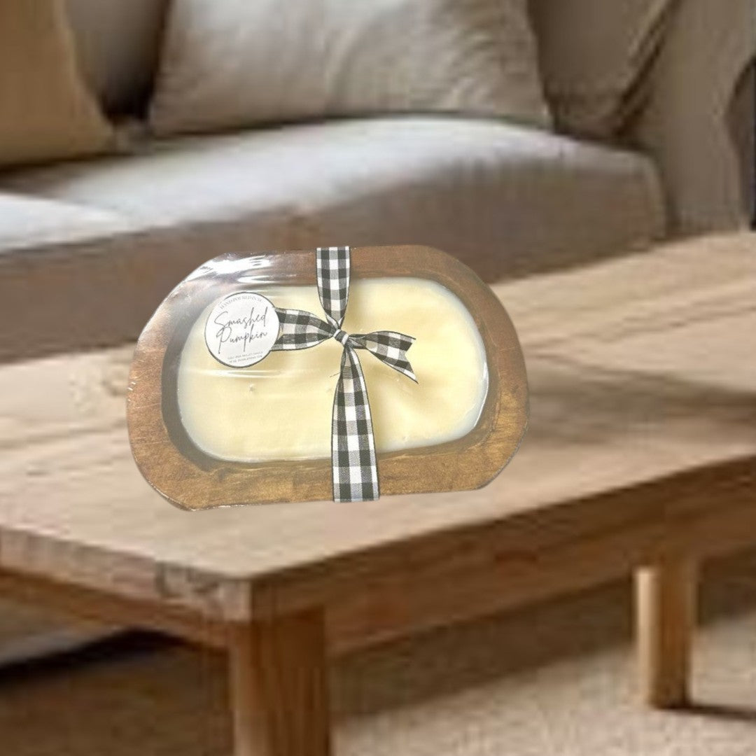 Doodlations Smashed Pumpkin wooden dough bowl candle with black and white buffalo check ribbon.