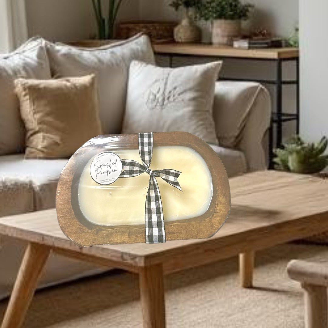 Doodlations Smashed Pumpkin wooden dough bowl candle with black and white buffalo check ribbon.