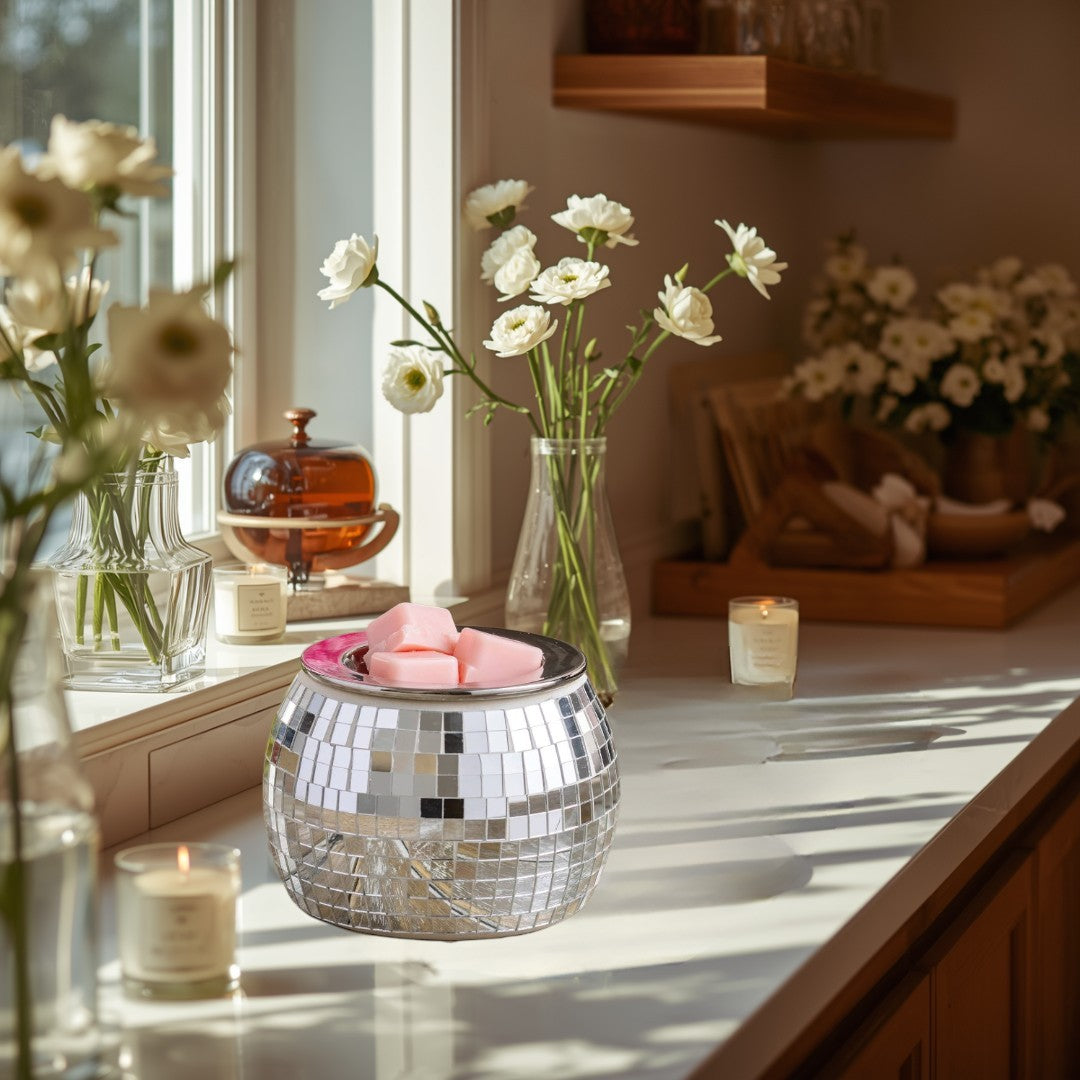 Disco Ball Fragrance Warmer with pink wax melts in a silver mirrored mosaic finish